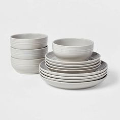 a stack of white dishes sitting on top of each other