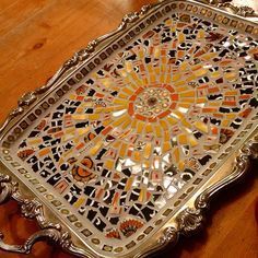 a silver tray sitting on top of a wooden table