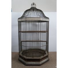 a bird cage sitting on top of a floor