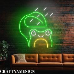 a green neon sign on the side of a brick wall next to a brown couch