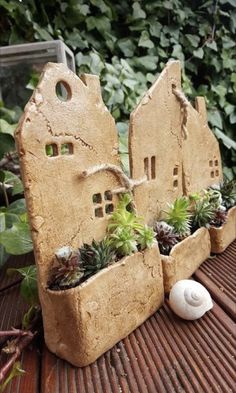 an outdoor planter with succulents and plants in it on a wooden table