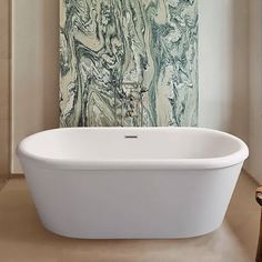 a white bath tub sitting in a bathroom next to a painting