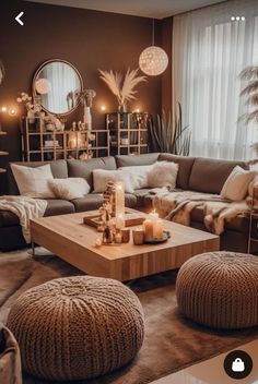 a living room filled with lots of furniture and candles on top of it's coffee table