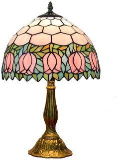 a lamp that is on top of a white surface with a pink flower in the middle