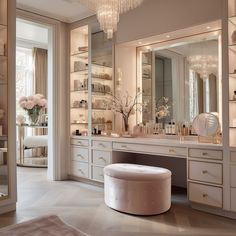 an elegant bathroom with chandelier, vanity and stool