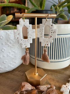 These are clay earrings that are in an Aztec shape and textured with brown tassels on the bottom connected by a gold ball stud and gold hardware! Earrings With Tassels, Aztec Clay, Oklahoma City, Clay Jewelry, Clay Earrings, Oklahoma, Gold Hardware, Jewelry Earrings Dangle, Tassels