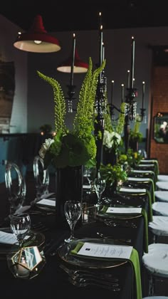 the table is set with green and white place settings