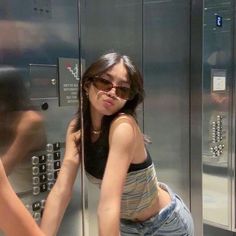 a woman is leaning against an elevator door