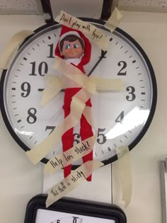 a clock with an elf's face on it and some tape wrapped around it