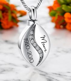 a personalized necklace with the name and date on it