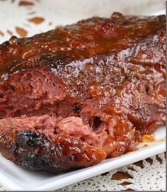 a piece of meat sitting on top of a white plate