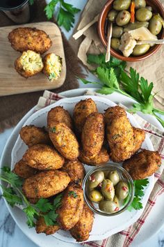 an appetizer platter with olives and breadcrumbs