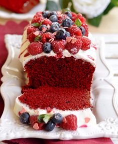 a slice of red velvet cake with berries on top