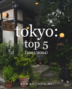 an advertisement for tokyo top 5 in front of a building with potted plants on the sidewalk