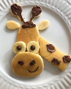 a white plate topped with cookies shaped like a dog