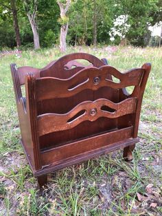 an old wooden bed frame sitting in the grass