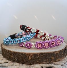 three bracelets sitting on top of a piece of wood