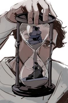 a man holding an hourglass in front of his face