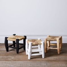 two stools made out of wicker sit on the floor