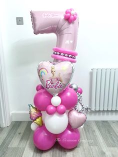 a balloon shaped like a number one sitting on top of a floor next to balloons