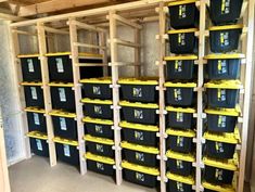 the storage room is filled with black and yellow bins