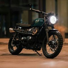 a motorcycle parked in front of a building with a light on it's headlight