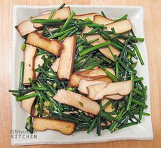 a white plate topped with green beans and mushrooms