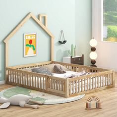 a child's room with a doll house bed and toys on the floor in front of it