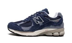 The New Balance 2002R “Refined Future - Navy” is a navy-based colorway of the retro running and lifestyle shoe that modifies its design with a pre-distressed look.  New Balance’s “Refined Future Pack” of 2002R colorways is similar to the “Protection Pack” as the former also updates the 2002R’s design with a deconstructed look.  The “Navy” features a weathered appearance with frayed overlays that suggest prolonged wear.  Navy mesh appears on the base and tonal suede overlays are found throughout.  A tonal “N” logo is found on either side.  The white ABZORB cushioned midsole is paired with New Balance’s N-ergy outsole to provide a smooth and responsive ride. Sporty Navy New Balance Sneakers, Navy Running Shoes With Boost Midsole For Streetwear, Casual Navy New Balance Running Shoes, Navy Sneakers With Vibram Sole For Streetwear, Casual Navy Sneakers For Running Errands, Casual Navy Sneakers For Errands, Casual Navy Sneakers, Basket New Balance, New Balance 2002r Protection Pack