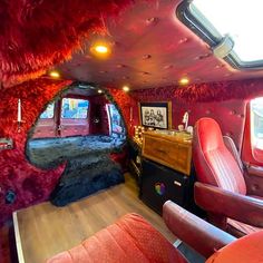 the interior of a vehicle with red fur on the walls and leather seats in it