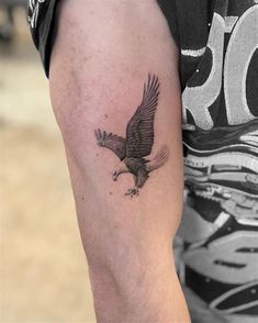 an eagle tattoo on the arm of a man