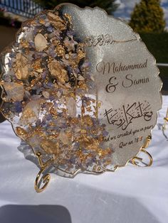 a close up of a plate on a table with flowers and other items in it