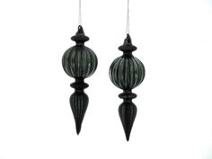 two black glass ornaments hanging from strings on a white background with clipping for text