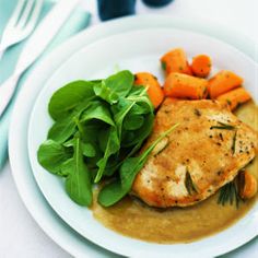 a white plate topped with chicken, carrots and spinach