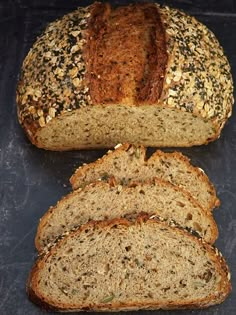 sliced loafs of bread sitting on top of a black countertop next to each other