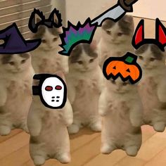 three white cats with halloween decorations on their heads and eyes are standing next to each other in front of a radiator