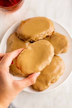 a white plate topped with cookies covered in peanut butter