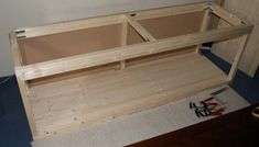 a wooden bench sitting on top of a carpeted floor