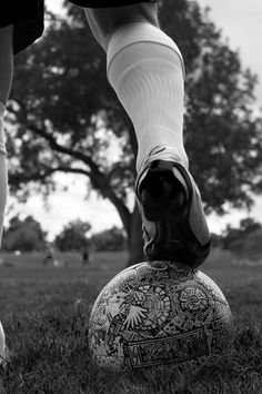 a person standing on top of a soccer ball