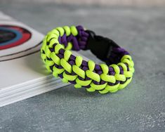 a yellow and purple bracelet sitting on top of a book