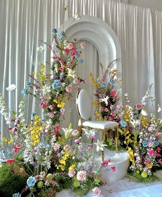 a chair sitting in front of a bunch of flowers