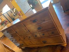 a wooden dresser sitting on top of a hard wood floor