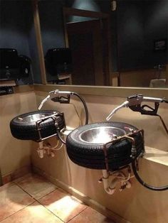 there are two sinks in the bathroom with black tires on each sink and chrome faucet