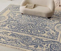 a blue and white area rug with an ornate design on the bottom, in a living room