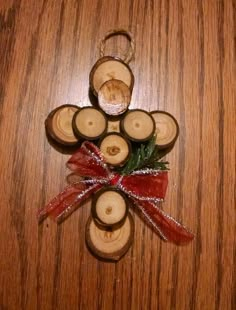 an ornament made out of wooden slices with red ribbon