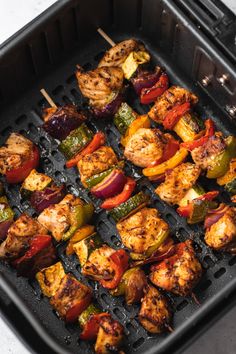 chicken and vegetable kabobs are being cooked on the griddles with toothpicks