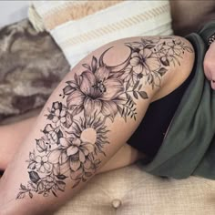 a woman is laying on the couch with her legs crossed and flowers all over her body