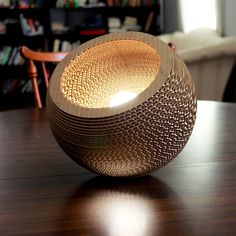 a wooden table topped with a lamp on top of it next to a book shelf