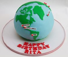 a birthday cake made to look like the world is on top of a plate with name tags