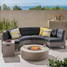 an outdoor fire pit surrounded by furniture